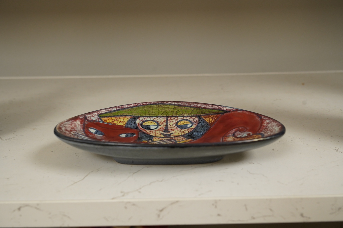 A Michael Andersen lustre stylised 'girl hugging a cat' dish, 20.5cm wide. Condition - good